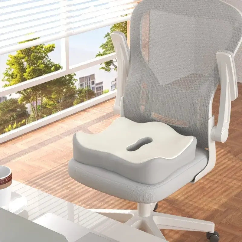 Ergonomic memory foam seat cushion for car and office use, designed to relieve hip pressure with a hollow cutout.