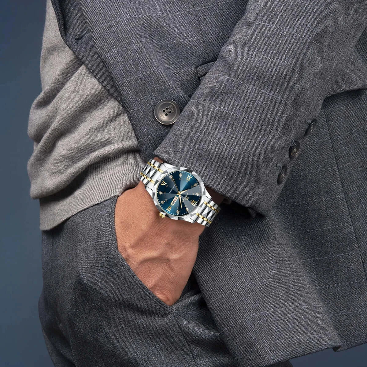Men's luxury blue and gold watch showcased on a man's wrist in a stylish gray suit.