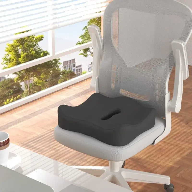Ergonomic black memory foam seat cushion on a modern office chair, designed for comfort and hip pressure relief.