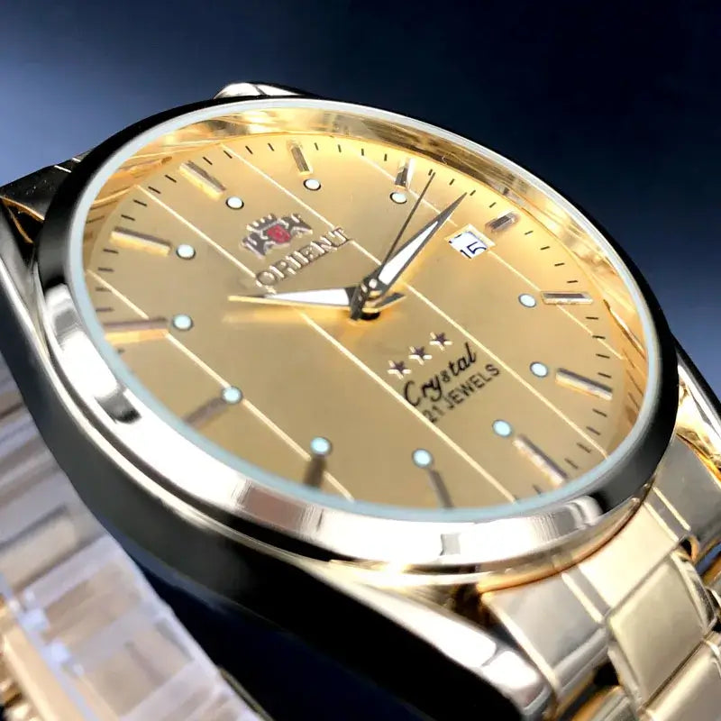 Orient luxury men's watch with gold dial, automatic mechanical tourbillon, and stainless steel design.