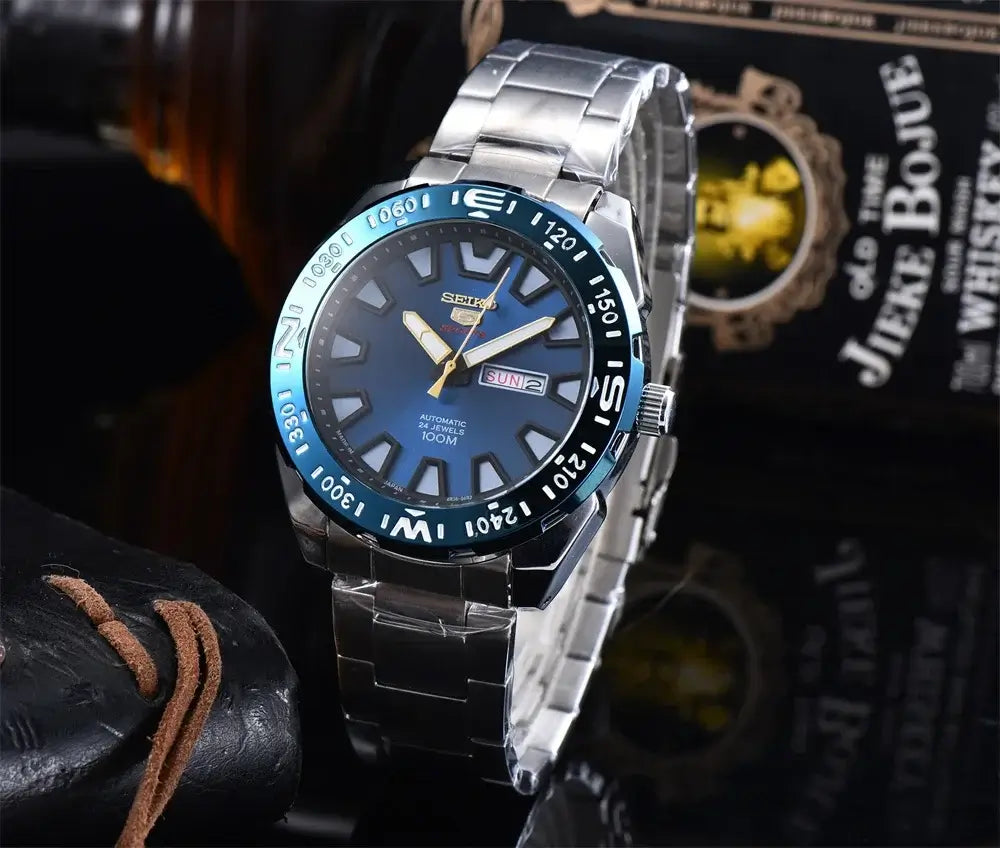Seiko SRP747J men's automatic quartz diving watch with luminous dial and steel band, 100M water resistance.