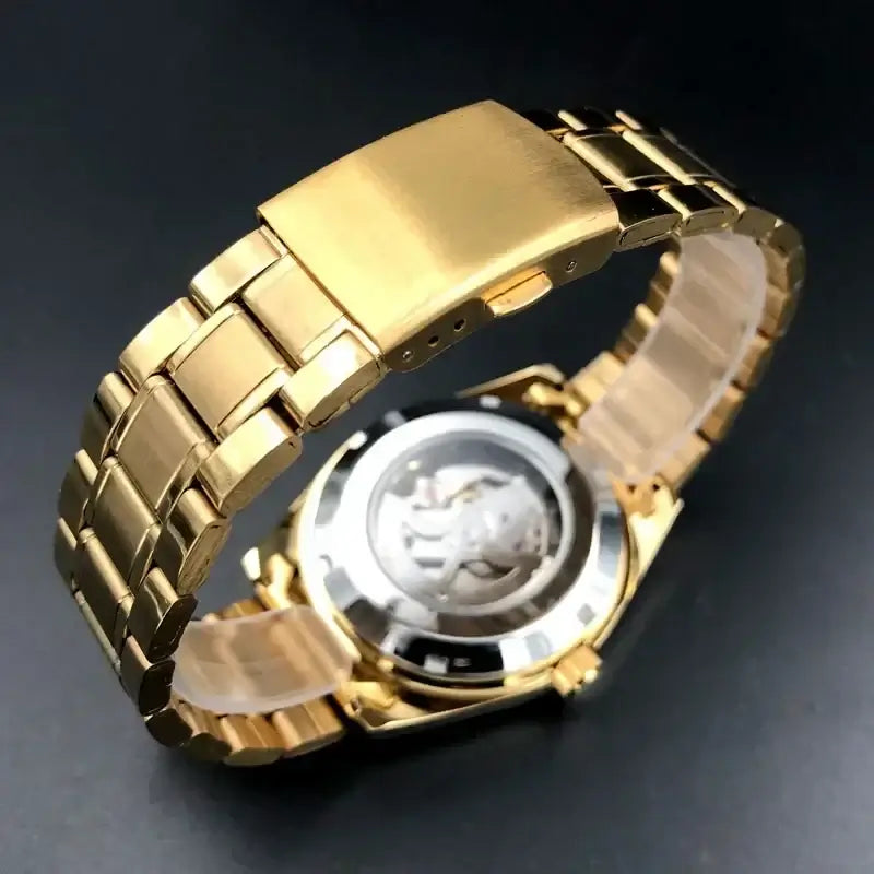 Close-up of Orient watches luxury multi-function automatic watch with gold stainless steel band and visible tourbillon mechanism.