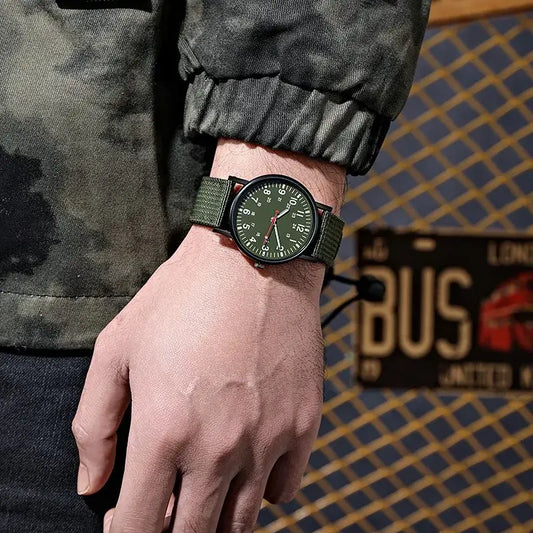 Men's green luminous quartz watch with big dial, worn on wrist, set against urban background. Waterproof fashion accessory.