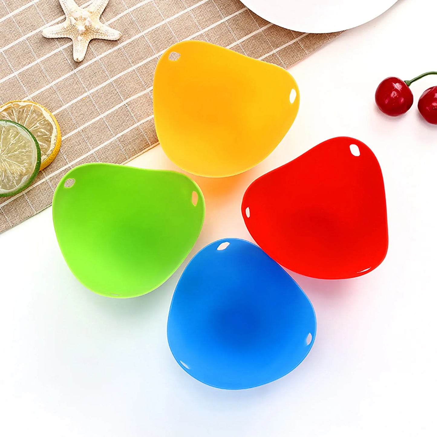 Colorful silicone egg poacher cups for microwave, air fryer, and stovetop cooking, set of four in yellow, red, green, and blue.