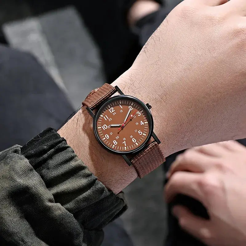 Men's luxury quartz watch with big brown dial and woven strap, showcasing style and elegance on wrist.