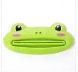 Cartoon frog-shaped toothpaste squeezer in green plastic, ideal for kitchen and bathroom use.