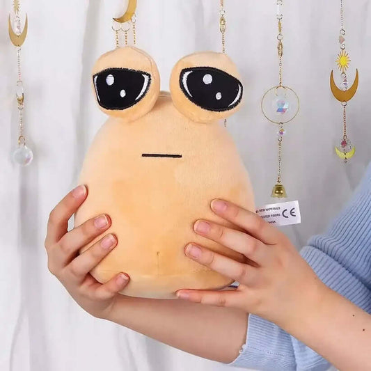 Soft beige frog plush toy with big eyes, held in hands against a whimsical background.