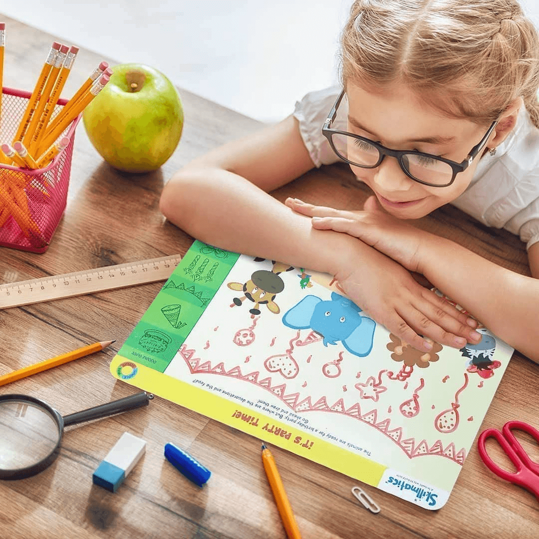 Child engaged with Skillmatics Doodle and Draw activity mat, surrounded by school supplies, enhancing creative and spatial skills.