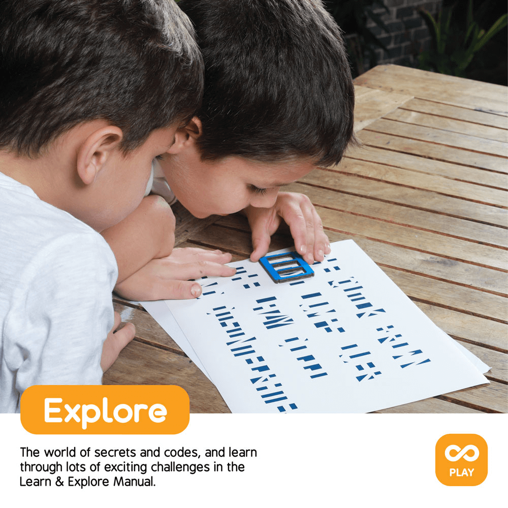 Two children solving a cryptic code with a magnifier, exploring and learning through engaging challenges in the Learn & Explore Manual.