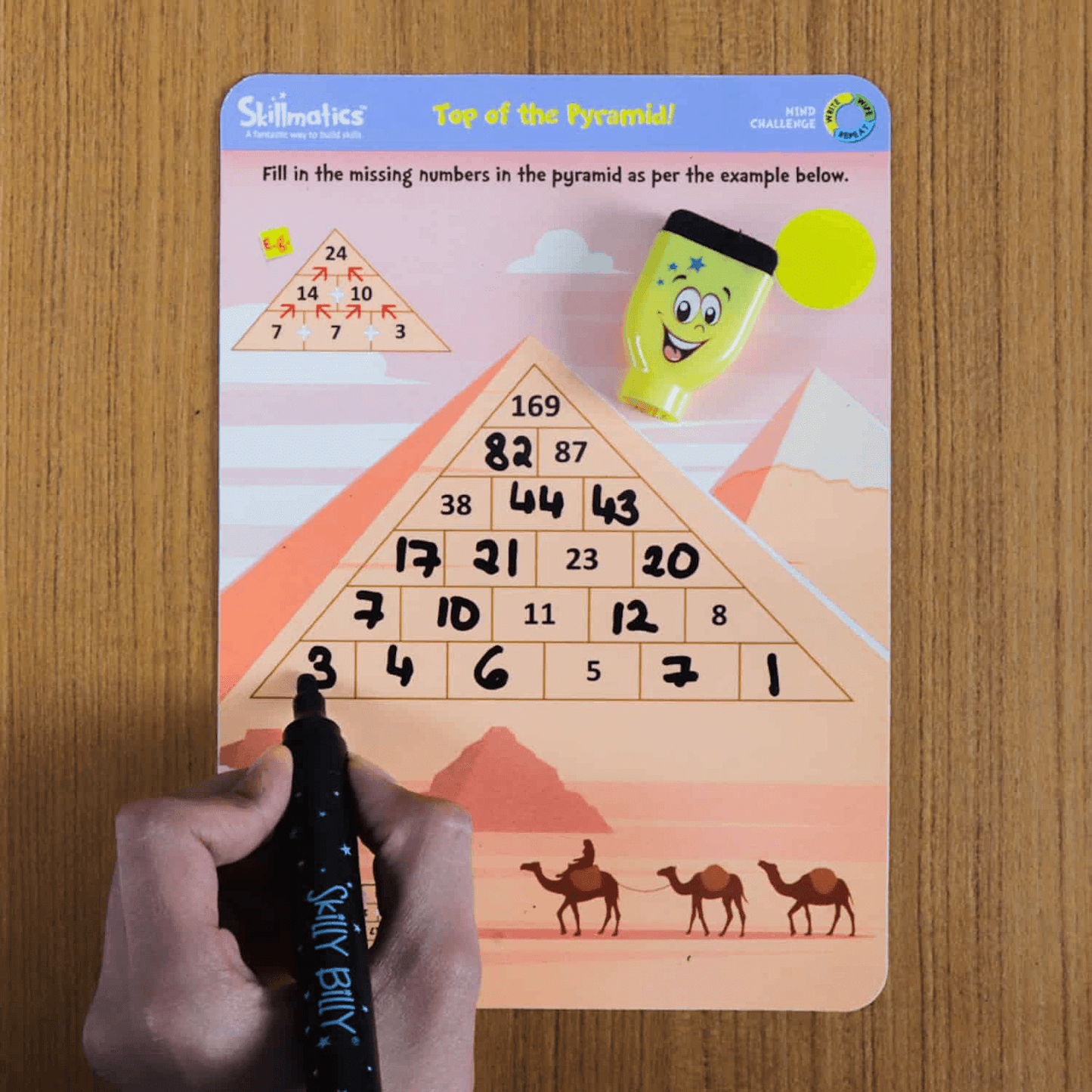 "Mind Challenge activity mat with Skilly Billy pen engaging kids in math problem-solving and strategy learning for ages 6-99."