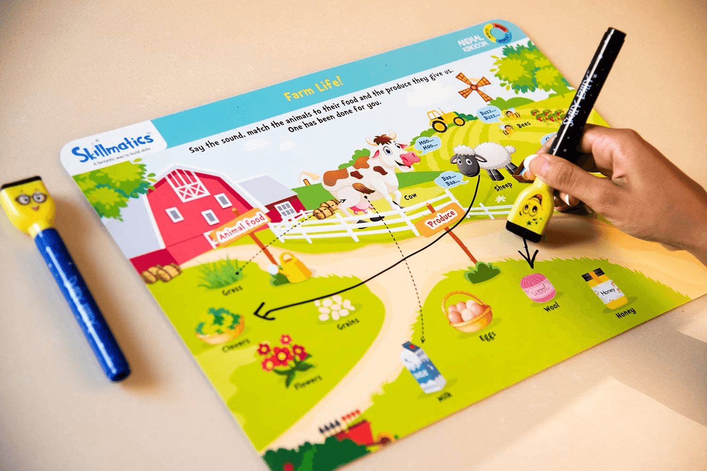 Kid using Skilly Billy pen on animal learning activity mat from "Animal Kingdom" set, ages 3-6, educational activities.