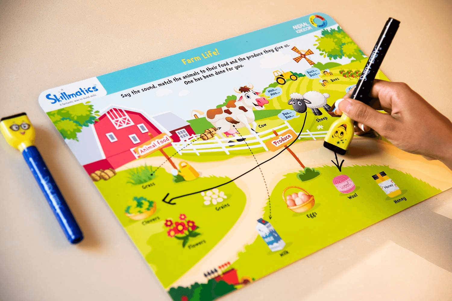 Kid using Skilly Billy pen on animal learning activity mat from "Animal Kingdom" set, ages 3-6, educational activities.