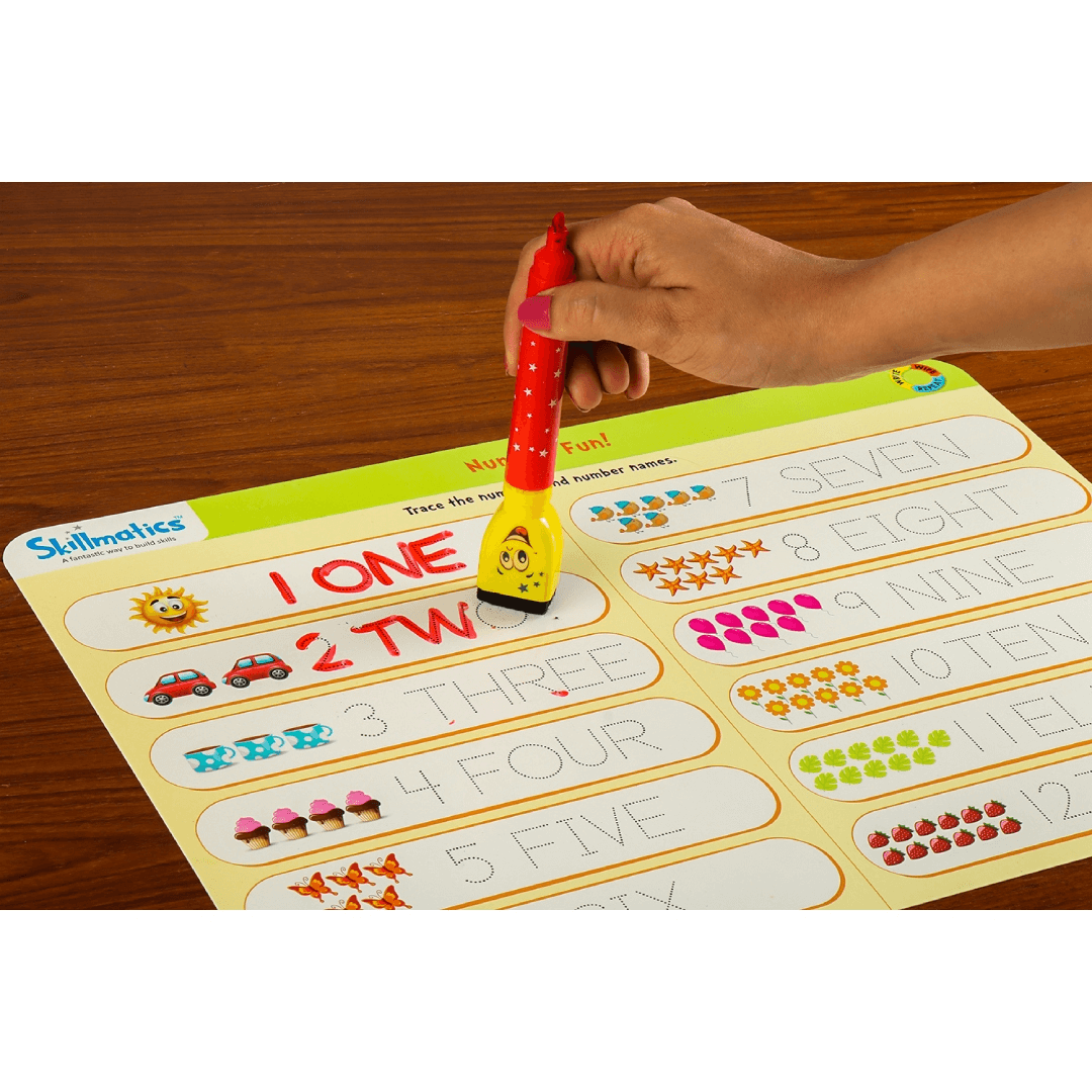 Writing numbers on an educational activity mat with a Skilly Billy pen for preschool kids aged 3-6.