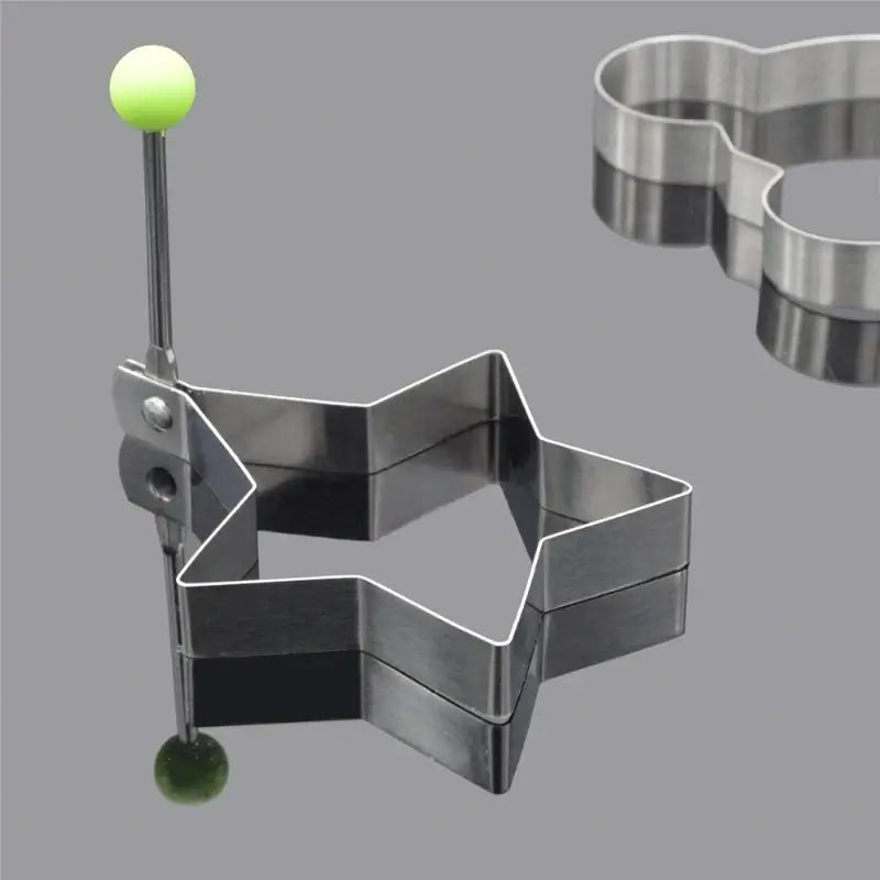 Stainless steel five-pointed star egg mold with green handle for pancakes and eggs.