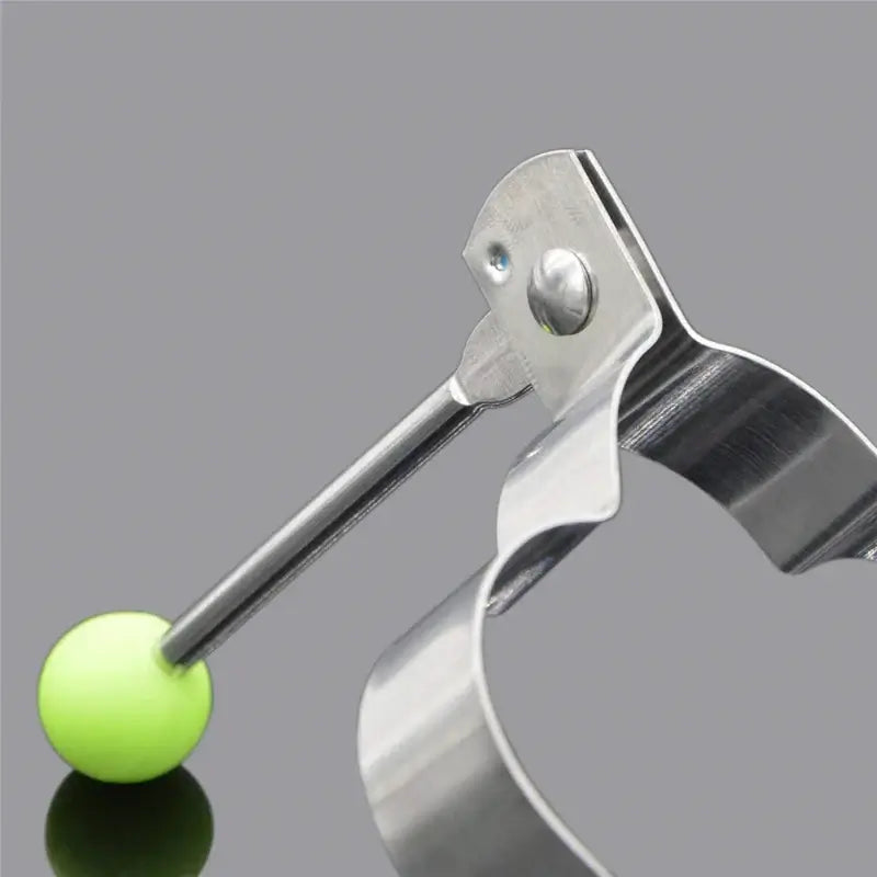 Stainless steel egg mold with a bright green ball handle for easy lifting and shaping.