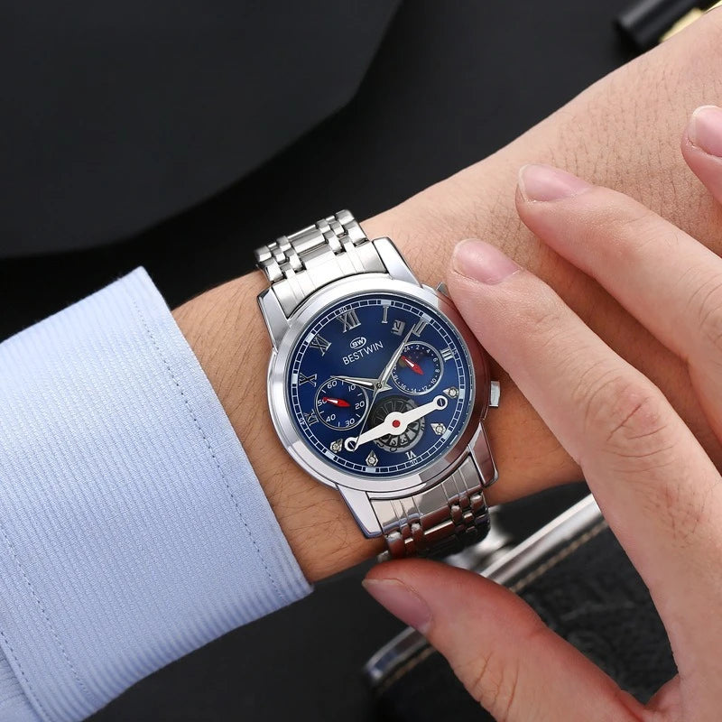 Luxury men's watch with moon phase on a wrist, showcasing premium stainless steel and elegant blue dial.