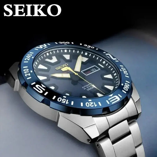 Seiko SRP747J automatic dive watch with luminous face, steel band, and blue bezel, showcasing classic retro style.