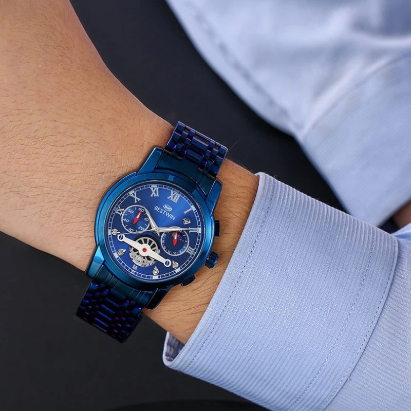 Luxury men's watch with moon phase and calendar, showcasing a blue stainless steel design on a wrist.