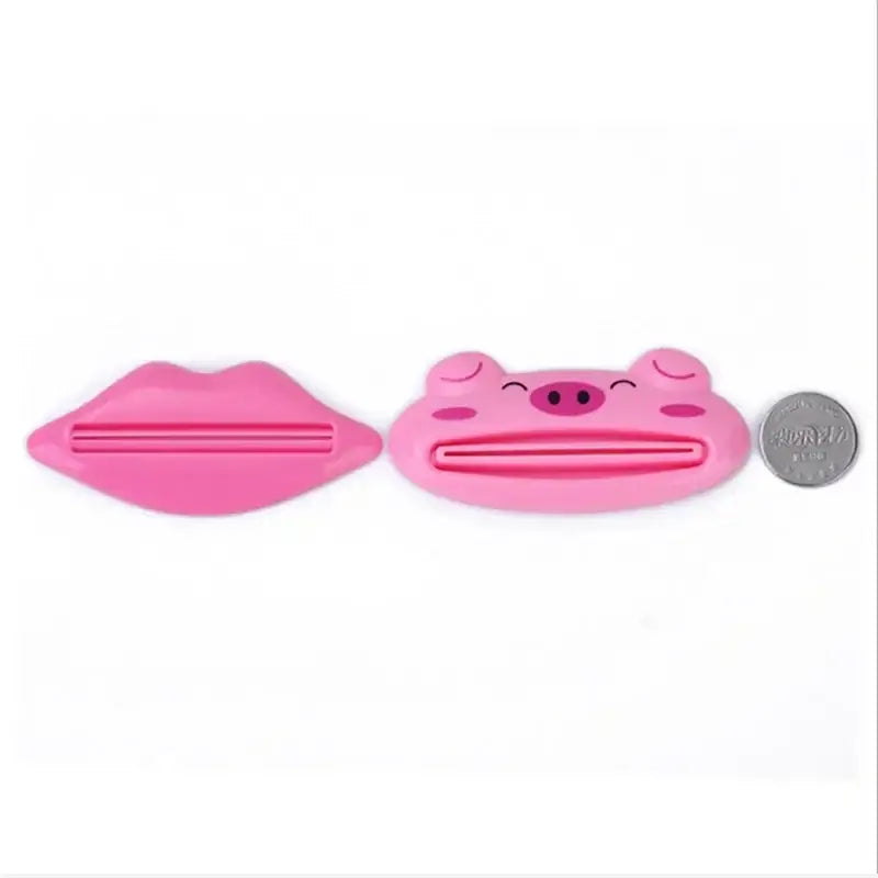 Cartoon multi-function toothpaste squeezer in pink lip and pig designs, perfect for bathroom and kitchen use.